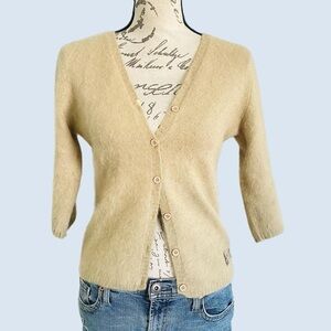Tan knit sweater with button front and ribbed hem, cuffs, and neckline